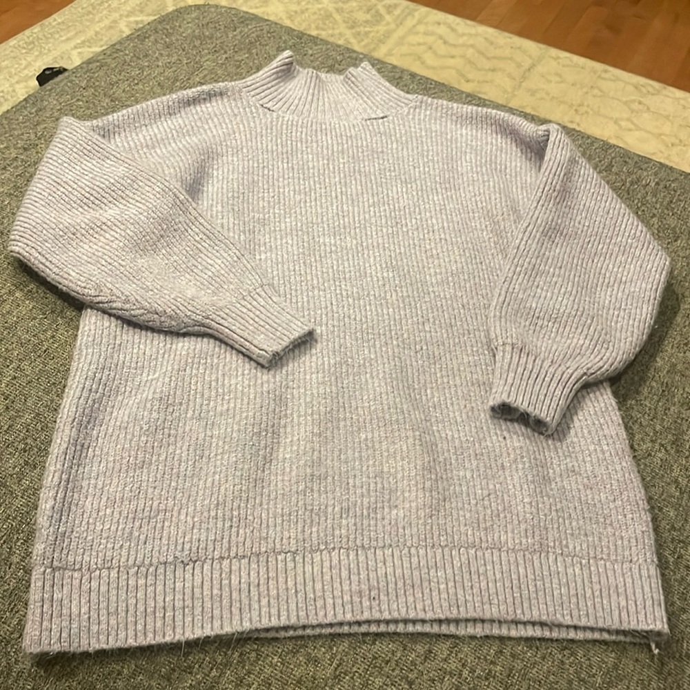 Purple turtleneck sweater with some tears in neckline